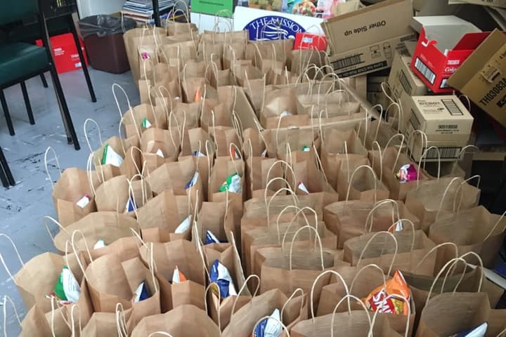A large collection of paper bags filled with groceries.