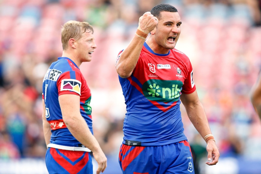 A Newcastle Knights NRL player pumps his right fist as he celebrates a win over the Canberra Raiders.