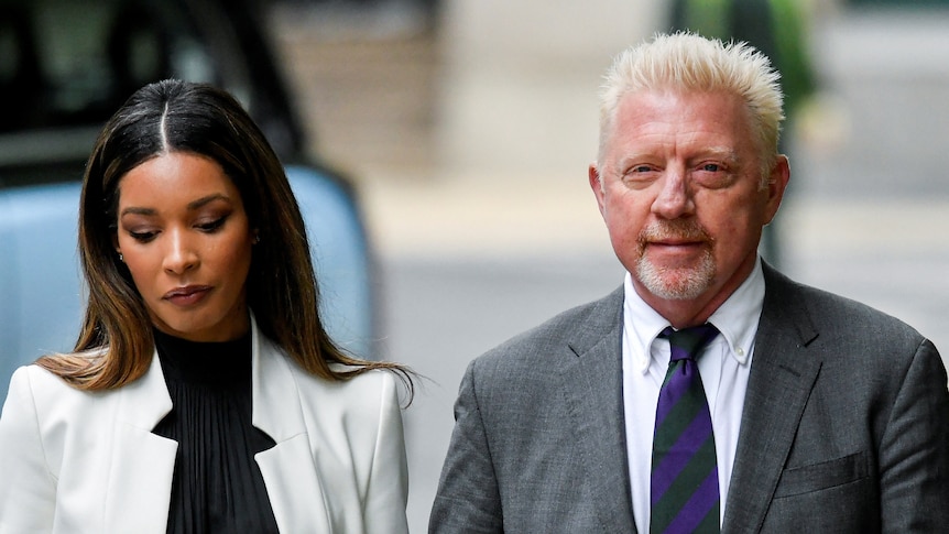 Boris Becker in suit walking beside woman on street