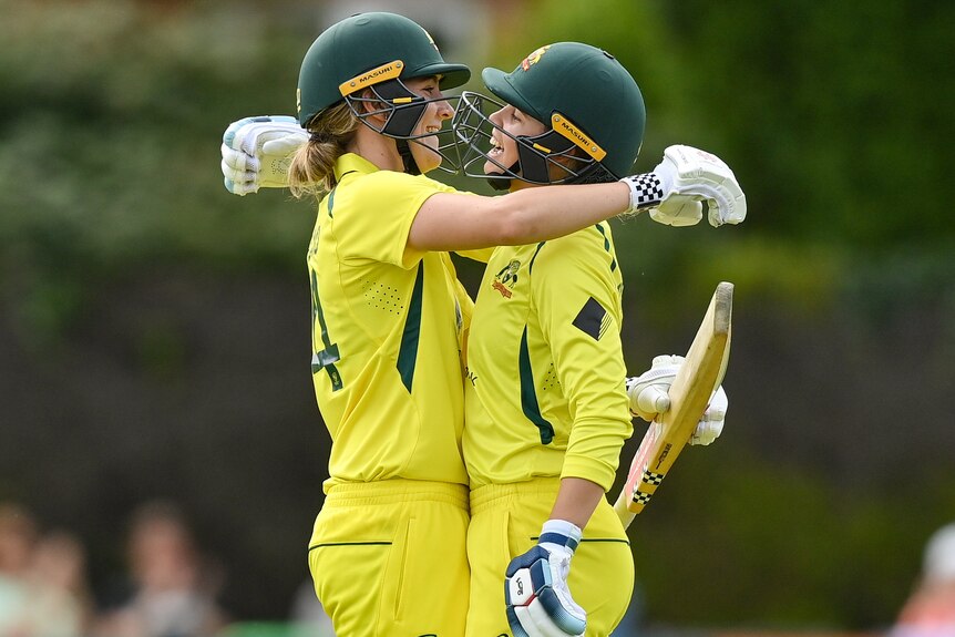 Two Australian players embrace as they celebrate a century against Ireland in the women's ODI.