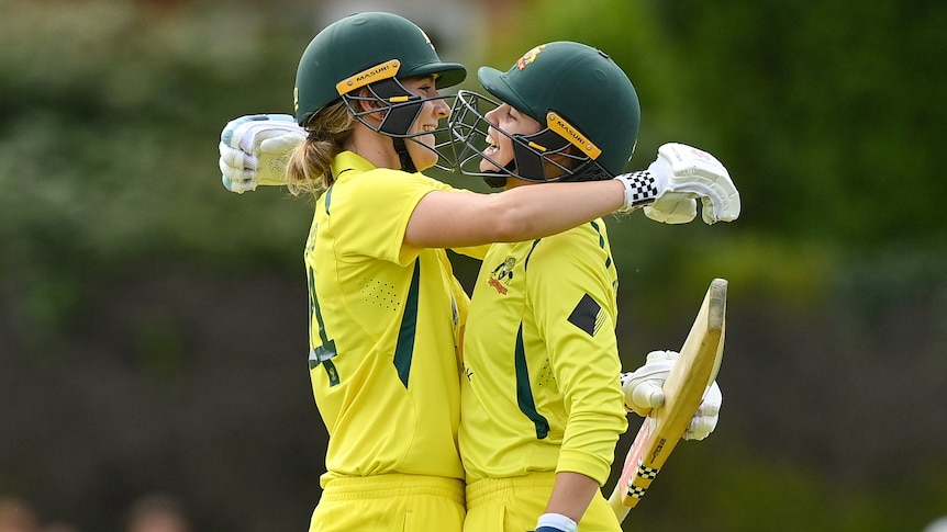 Two Australian players embrace as they celebrate a century against Ireland in the women's ODI.