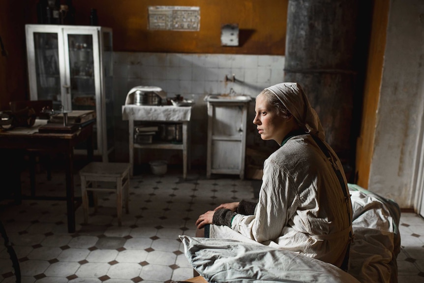Russian actor Viktoria Miroshnichenko in grey nurses clothes in the Russian film Beanpole