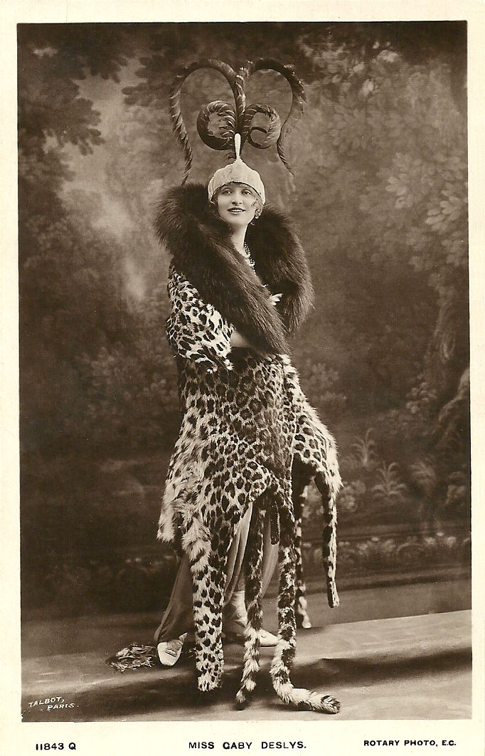 A black and white photo of a woman in the 1910s in a leopard skin cloak