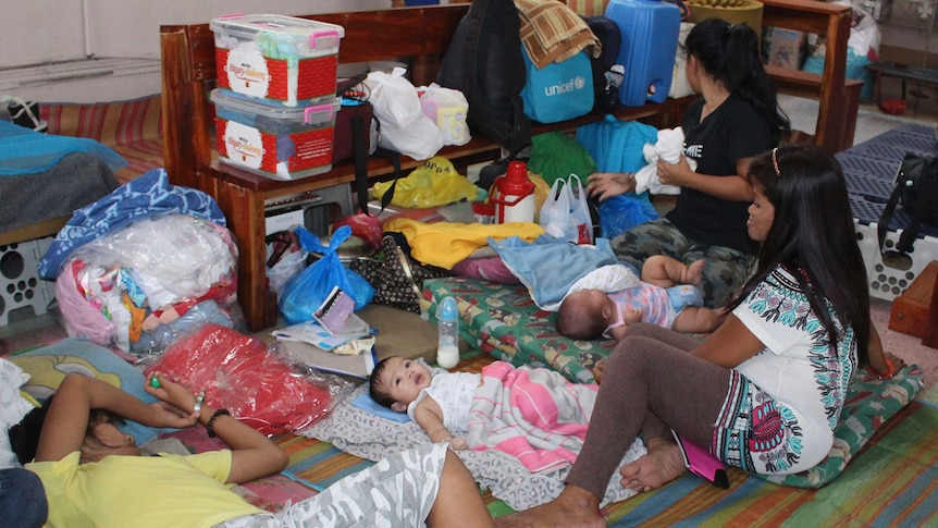 People shelter inside a church ahead of Typhoon Hagupit