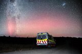 An ambulance vehicle with the aurora australis and stars in the background.