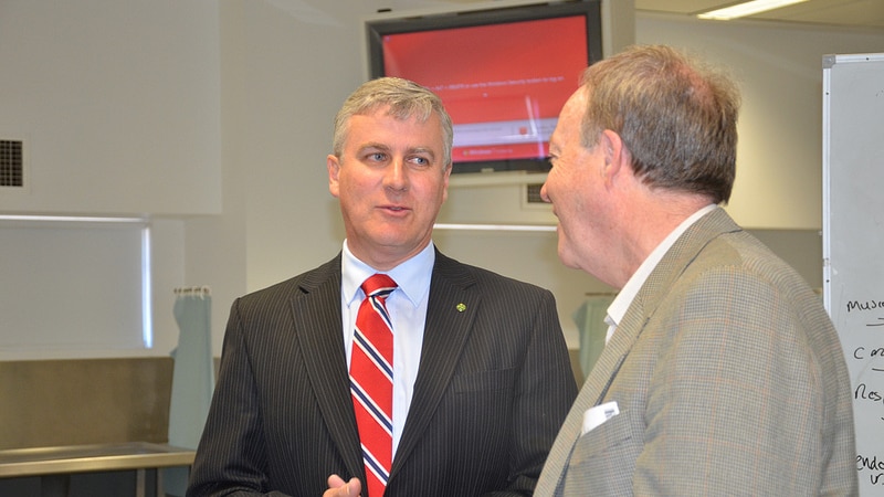 National Party MP Michael McCormack speaks with a colleague