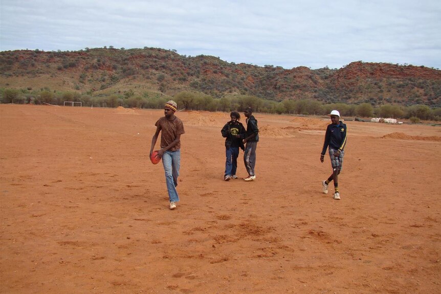 Indigenous children play on the Areyonga football oval
