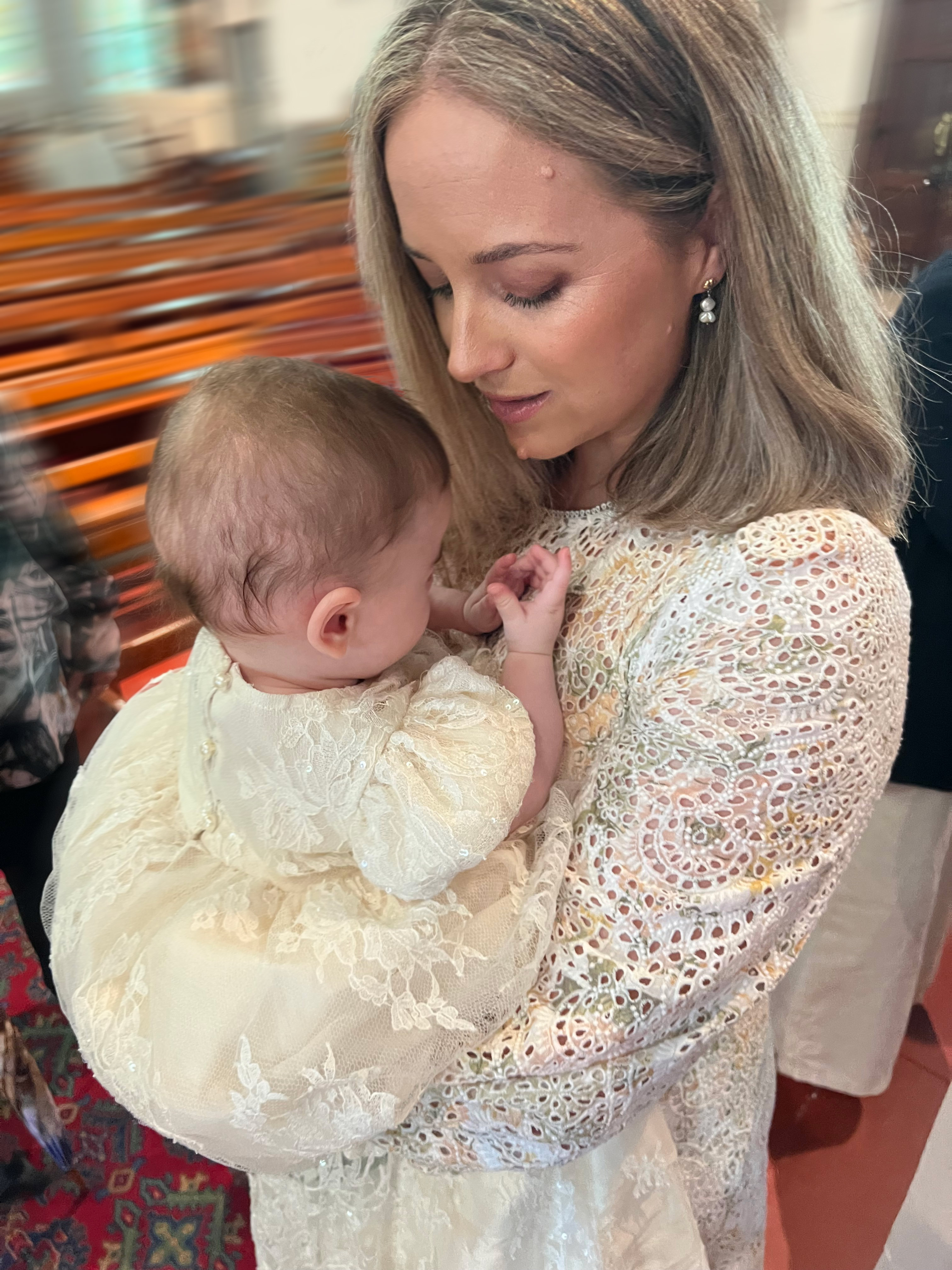 Caitlyn Gribbin looks down at her son, who she is nursing while standing