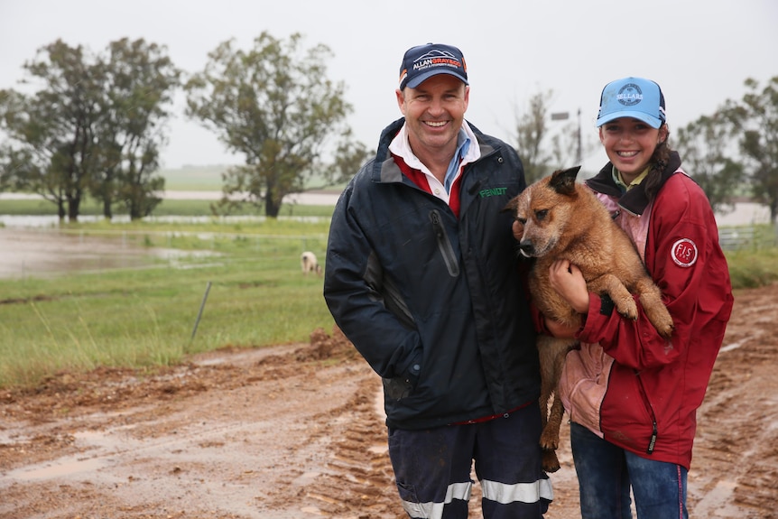 Canowindra farmer Boyd Thurgate, dog rosie and daughter Imogen at flooded farm