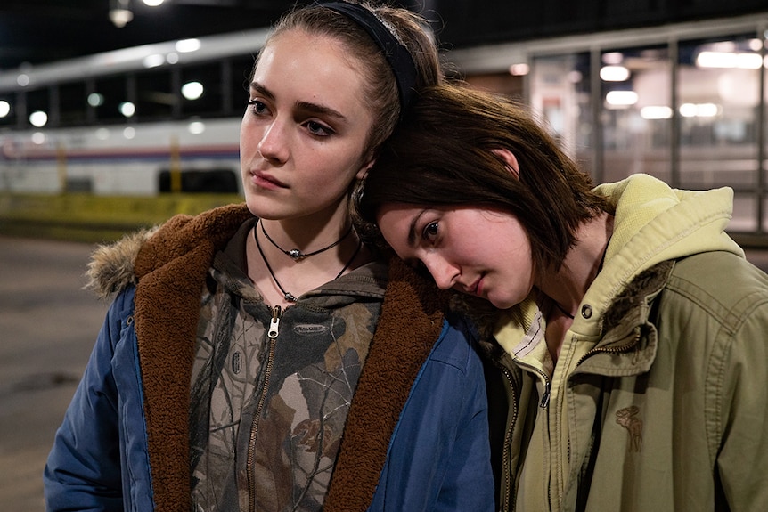 Film's main character, Autumn (Sidney Flanigan) resting her head on her cousin Skylar's (Talia Ryder) shoulder.