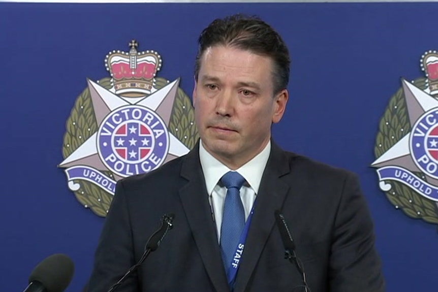 Inspector Tim Day stands at a lectern at Victoria Police headquarters.