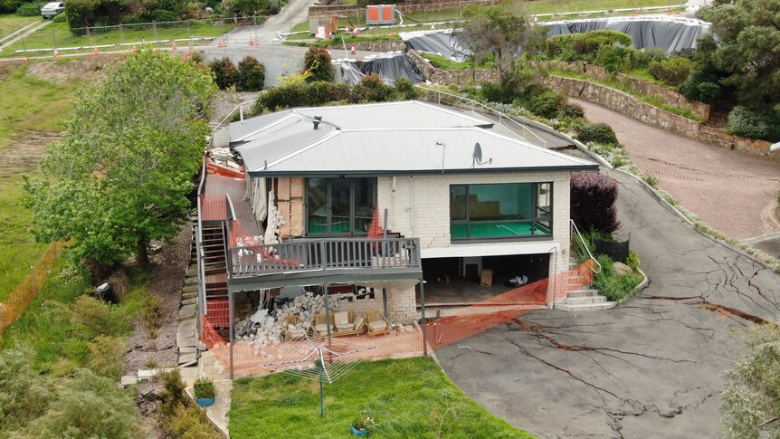 An aerial view of a house damaged by a slow moving landslide