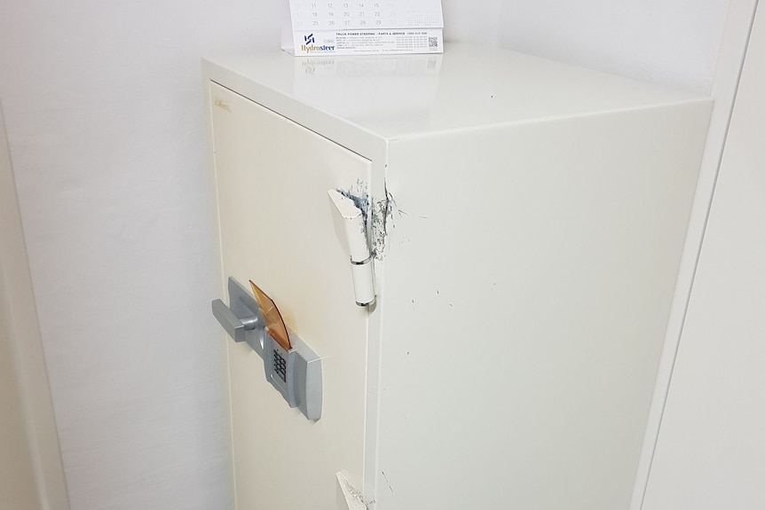 broken hinges and damage to white safe