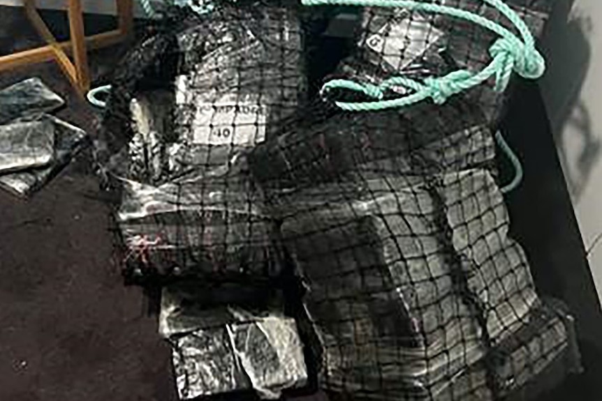 Packages wrapped in plastic and black netting 