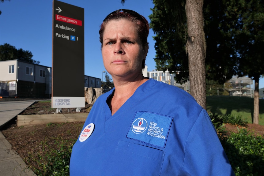 A female nurse outside of a hospital
