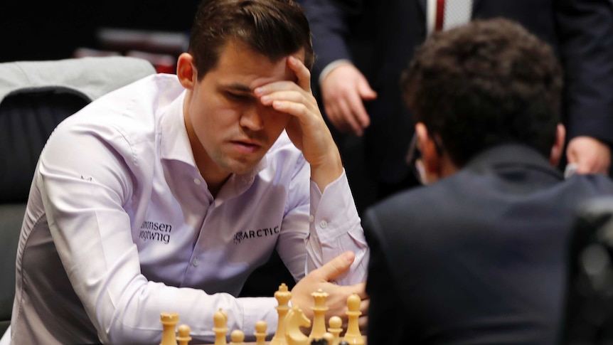 Magnus Carlsen studies the board during world chess championship