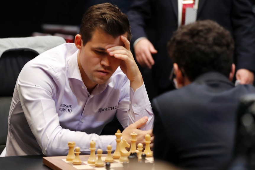 Magnus Carlsen studies the board during world chess championship
