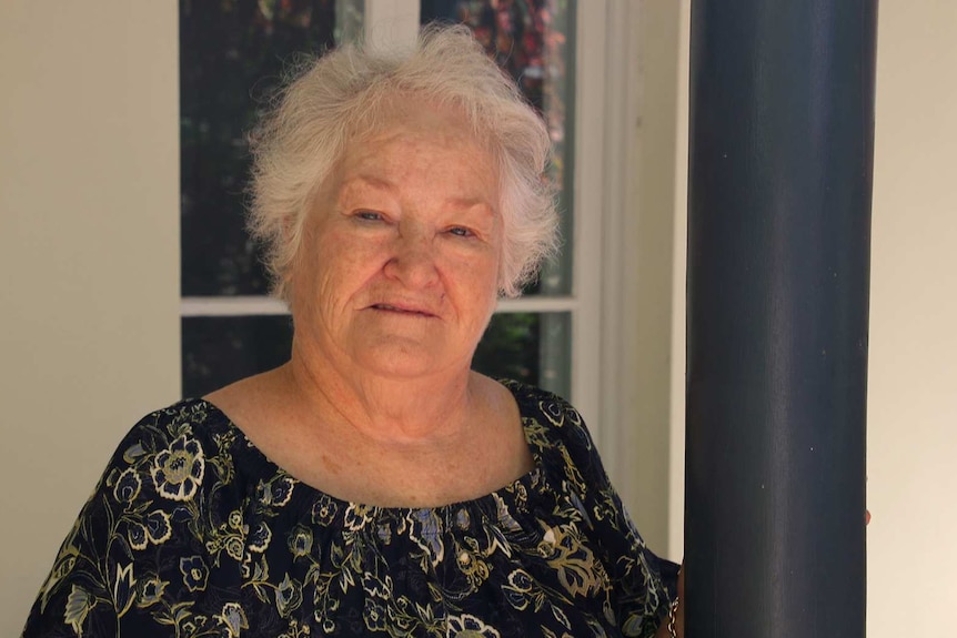 Patricia Gibson in a black top out the front of her house.