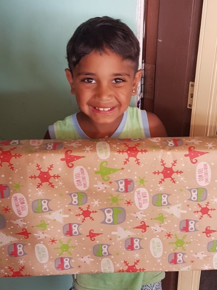 boy smiling hold large Christmas present