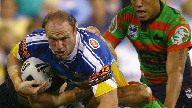 Luke Bailey charges forward with the ball into the Rabbitohs pack