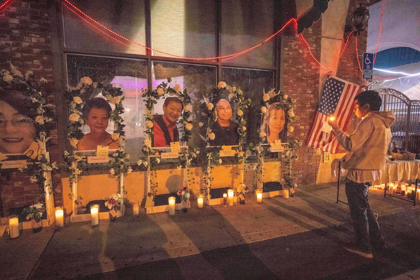 Pictures of victims are surrounded by flowers in a makeshift memorial.