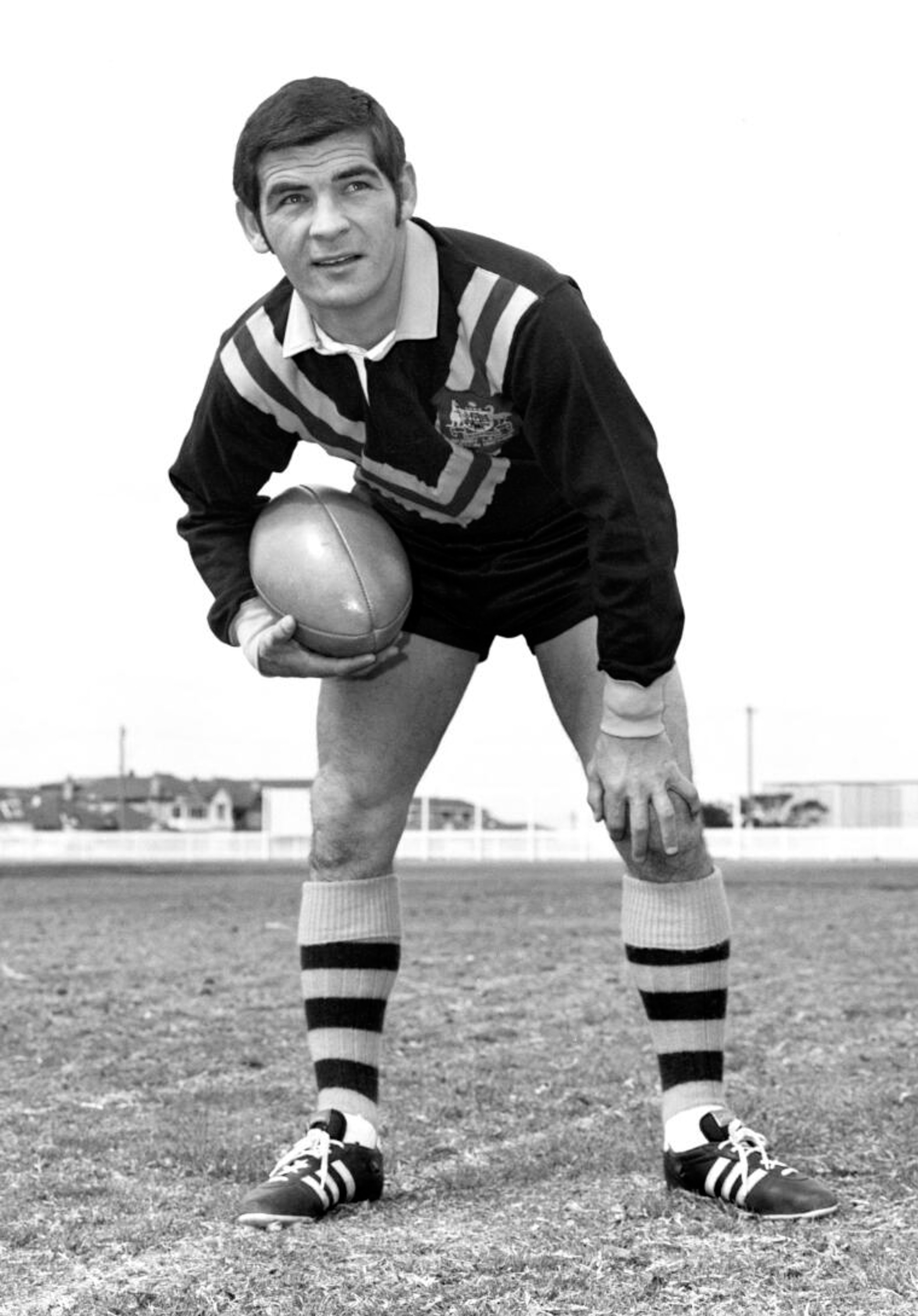 Ken Irvine fotografado com o uniforme da seleção australiana enquanto segura uma bola na década de 1960.