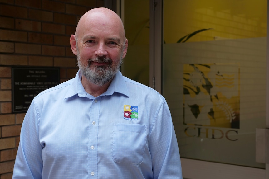 Arjan Bloemer stands outside his office building.