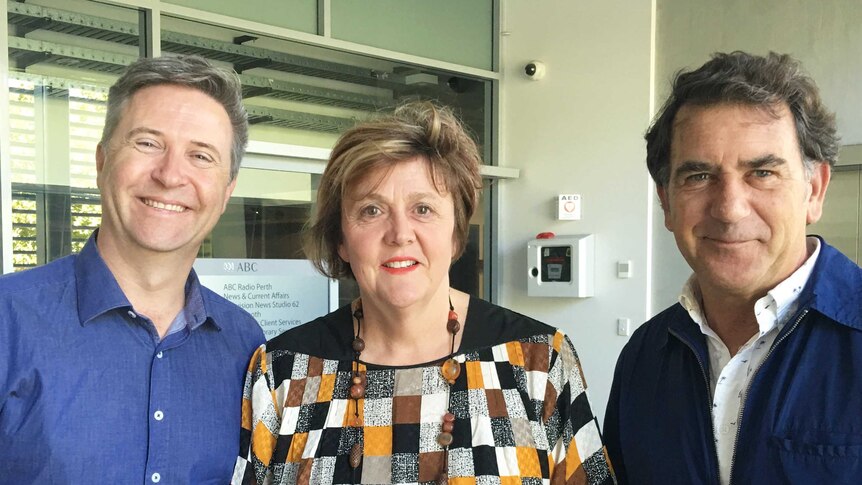 Two men and a women standing in a line and smile for the camera at the ABC's East Perth studios.