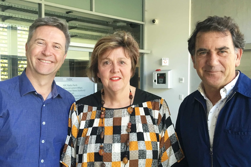 Two men and a women standing in a line and smile for the camera at the ABC's East Perth studios.