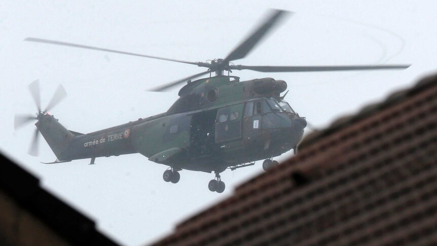 A French Army helicopter hovers near the scene of a hostage