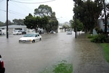 Cars make their way through floodwaters in Melbourne, December 1