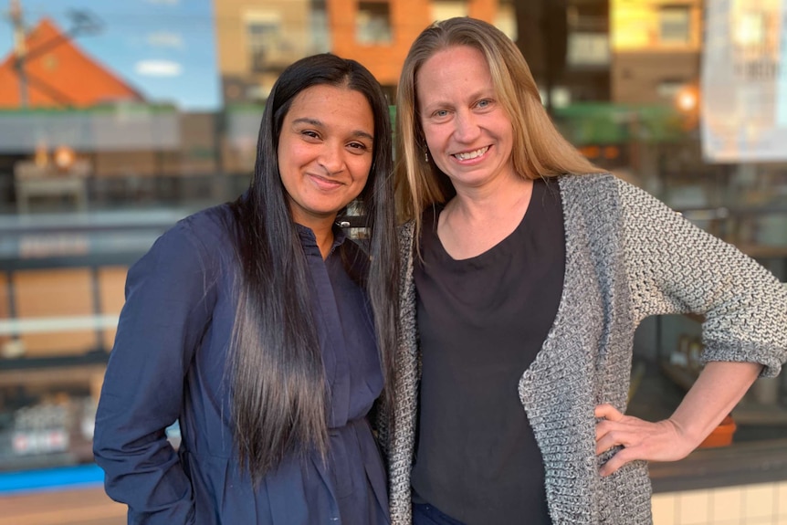 Two women standing next to each other.