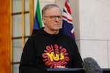 Prime Minister Anthony Albanese wearing a Yes hooded sweatshirt during a press conference. 