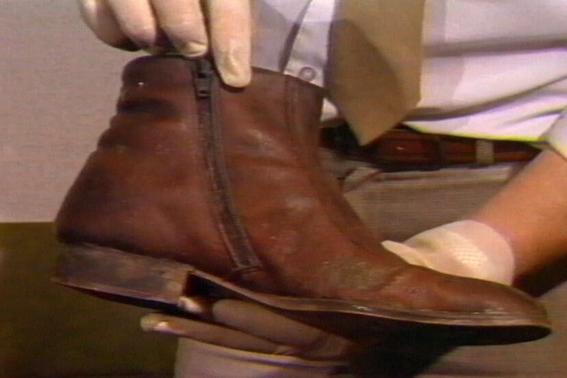 Police display the boot found on the leg in Launceston's Tamar River in 1984