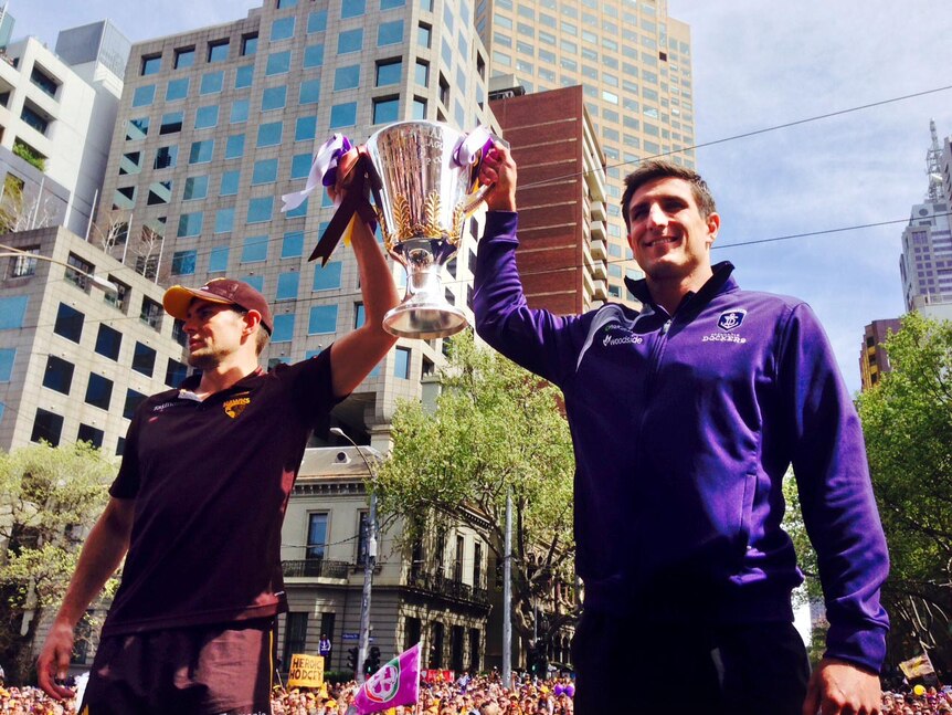 Luke Hodge and Matthew Pavlich. hold the AFL Premiership Cup at the Grand Final Parade.