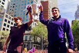 Luke Hodge and Matthew Pavlich. hold the AFL Premiership Cup at the Grand Final Parade.