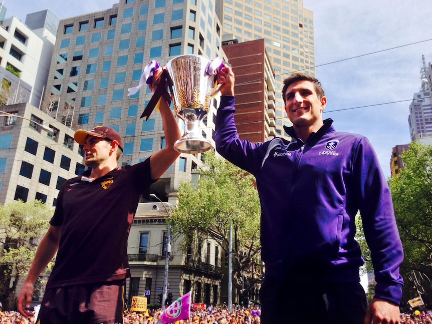 Luke Hodge and Matthew Pavlich. hold the AFL Premiership Cup at the Grand Final Parade.