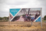 A sign that reads "Mildura Welcomes You" along with a photo of a group of people smiling outside the Mildura Airport.