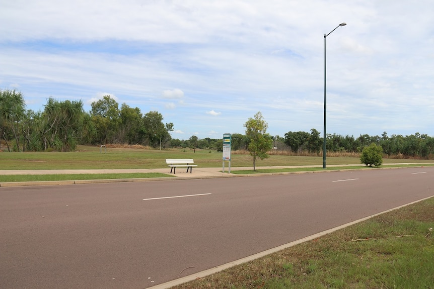 The bus stop has a seat, but no shelter