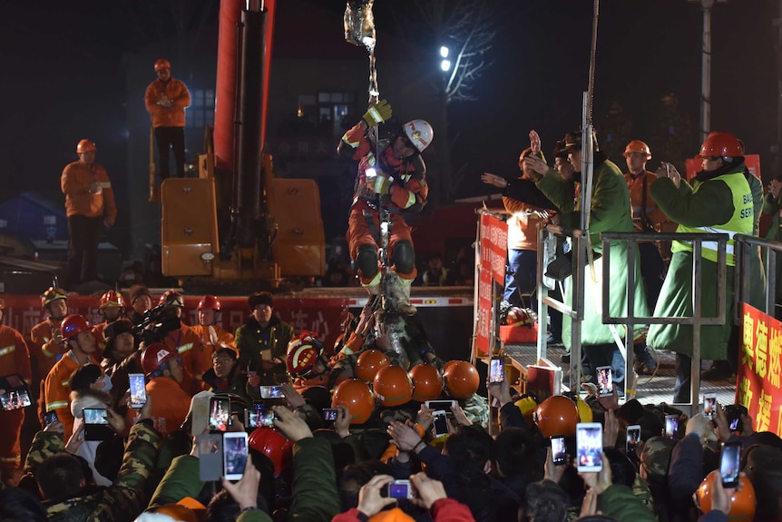 A trapped worker is lifted from a collapsed mine in China.