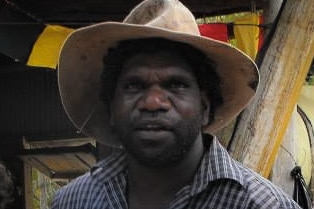 An Indigenous man wearing a broad-brimmed hat.