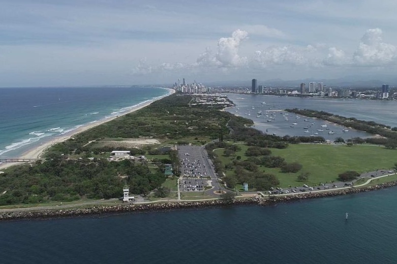 Aerial photo of land with beach and city views