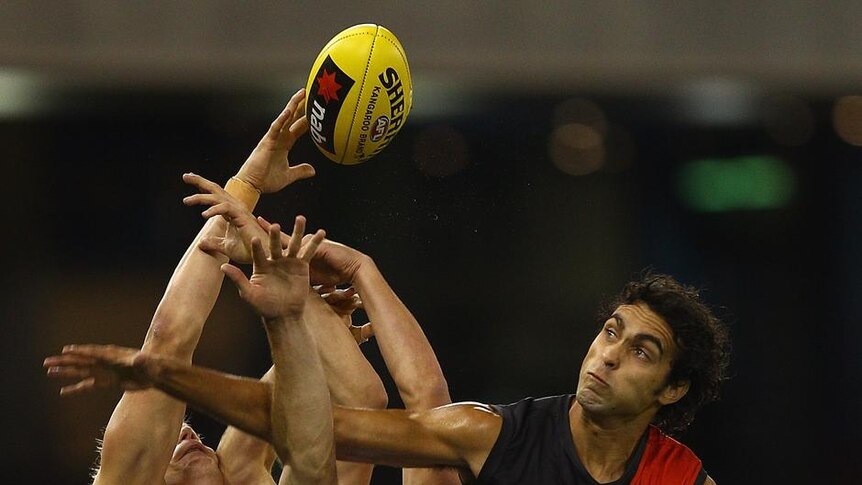 Courtenay Dempsey, one of Essendon's best, crashes the pack.