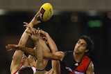 Courtenay Dempsey, one of Essendon's best, crashes the pack.