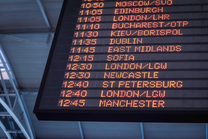 Airport display board showing destinations and times
