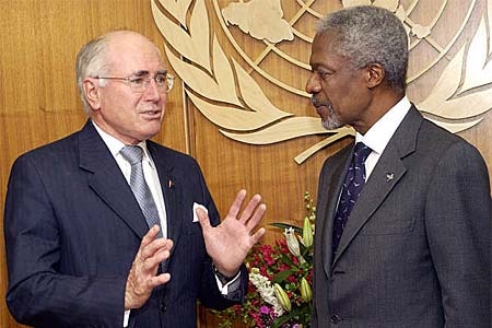 John Howard gestures while talking to Mr Annan.