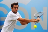 Croatia's Marin Cilic hits a backhand against Tomas Berdych at Queen's Club in June 2013.