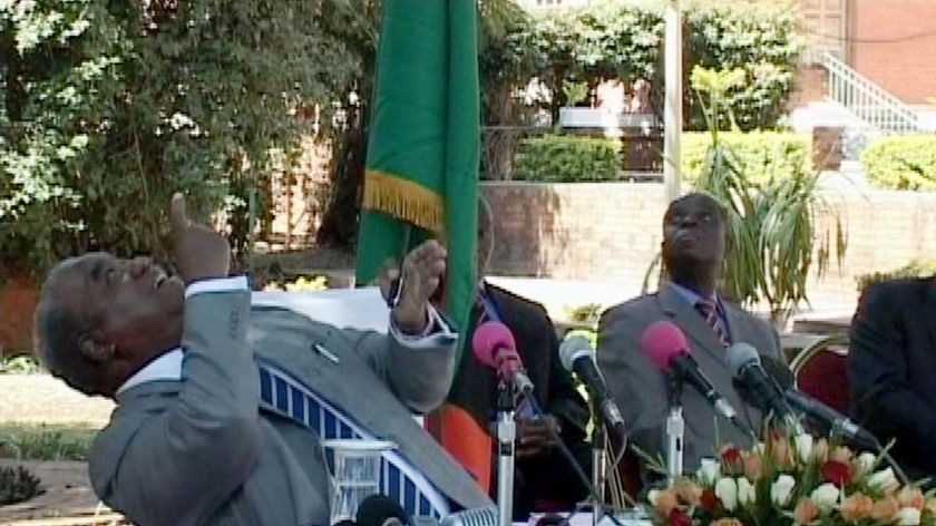 Zambian President Rupiah Banda reacts as a monkey urinates on him