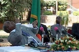 Zambian President Rupiah Banda reacts as a monkey urinates on him