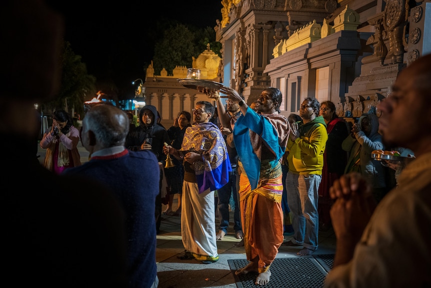 A photo of dancers outside the temple.
